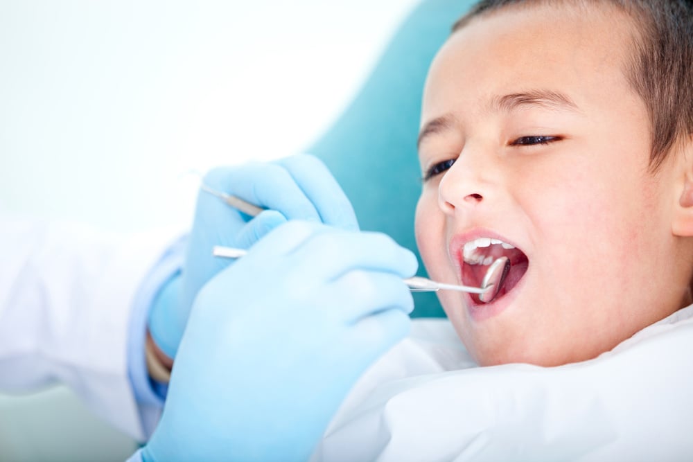 Boy visiting the dentist for cleaning and checkup Boy visiting the dentist for cleaning and checkup